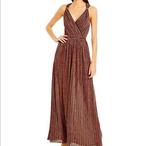 Elegant striped metallic gown. Crossover V-neck. Concealed back zip closure.